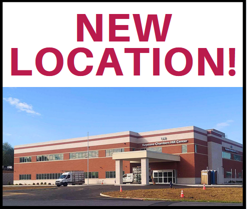 A large sign reads "NEW LOCATION!" above a photo of a modern, two-story brick building labeled "Keystone Chambers Hill Center," with a parking lot and vehicles in front.